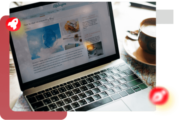 Laptop displaying website design with coffee cup on desk, web development workspace